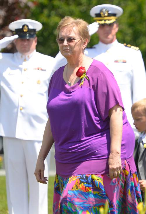 Leah Hogsten  |  The Salt Lake Tribune
Lorie Ricks follows the casket of her husband, Utah Transit Authority electrician Kay Ricks, 63, who was laid to rest Saturday, May 28 at Lehi City Cemetery. Ricks served in the Navy and was a veteran of the Vietnam War, 4 years active duty and 2 years in the Naval Reserve and 8 years in the Utah National Guard. Utah police continue gathering evidence that could link two men who fled to Wyoming, after tying up and assaulting a mother and her four teenage daughters in a Centerville home on May 10, to the slaying of Ricks employee whose body was found in rural Wyoming.