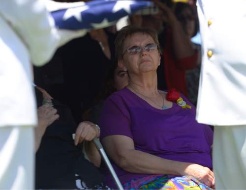 Leah Hogsten  |  The Salt Lake Tribune
Lorie Ricks watches as Naval officers fold the American Flag formerly draped over the casket of her husband, Utah Transit Authority electrician Kay Ricks, 63, who was laid to rest Saturday, May 28 at Lehi City Cemetery. Ricks served in the Navy and was a veteran of the Vietnam War, 4 years active duty and 2 years in the Naval Reserve and 8 years in the Utah National Guard. Utah police continue gathering evidence that could link two men who fled to Wyoming, after tying up and assaulting a mother and her four teenage daughters in a Centerville home on May 10, to the slaying of Ricks employee whose body was found in rural Wyoming.