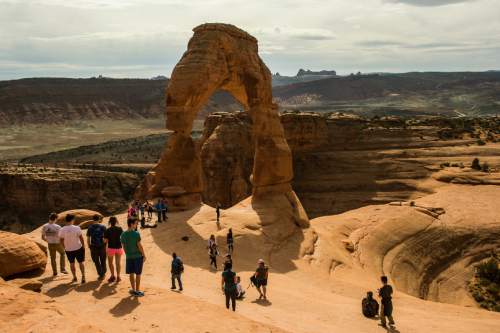 Chris Detrick  |  The Salt Lake Tribune
Visitors take pictures and hike around Delicate Arch in Arches National Park Saturday March 5, 2016.