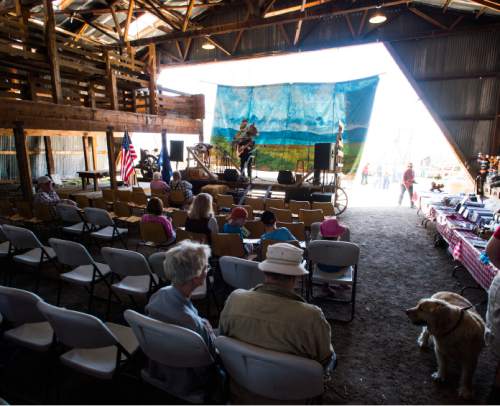 Steve Griffin / The Salt Lake Tribune

A painted back drop hangs from the barn as Stan Barnhart sings at the Annual Cowboy Poetry and Music Gathering
 at the Fielding Garr Ranch on Antelope Island Monday May 30, 2016. The celebration of the West featured  music, poetry, wagon rides, children's activities, food.