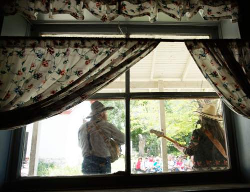 Steve Griffin / The Salt Lake Tribune

Allan and Corean Romriell perform on the porch of a house at the Annual Cowboy Poetry and Music Gathering
 at the Fielding Garr Ranch on Antelope Island Monday May 30, 2016. The celebration of the West featured  music, poetry, wagon rides, children's activities, food.