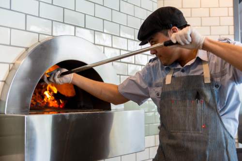 Trent Nelson  |  The Salt Lake Tribune
Several dining establishments have sprung up along Gallivan Avenue in downtown Salt Lake City, including From Scratch. In this 2014 photo, 
Luis de la Riva works the pizza oven at From Scratch.