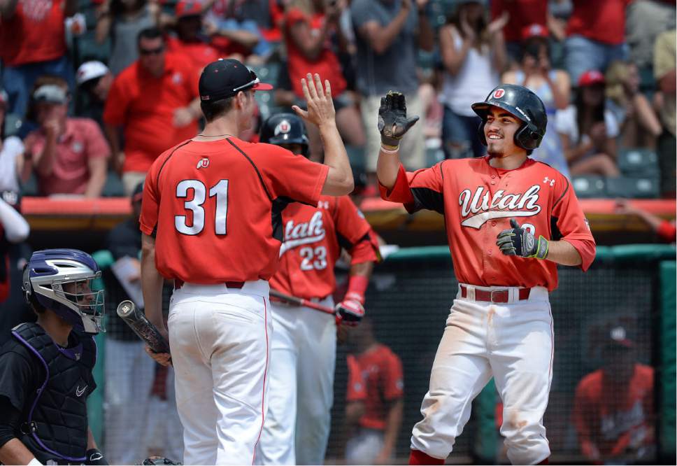 Scott Sommerdorf   |  The Salt Lake Tribune  
Cody Scaggari is greeted at home plate after his home ruin made the score 11-2 in the 6th. Utah wins the Pac-12 baseball championship by defeating Washington, Sunday, May 29, 2016.