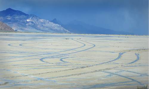 Scott Sommerdorf   |  The Salt Lake Tribune  
Tire tracks left by unknown drivers were not hard to see on the slat flats on Friday, May 27, 2016. despite the numerous signs warning motorists to stay off the salt flats near the Bonneville Speedway..