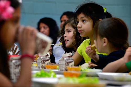 Scott Sommerdorf   |  The Salt Lake Tribune  
Alarick Davenport, center, and Natalie Estrada, right, eat their lunch of chicken fingers, salad and a fruit cup at Esperanza Elementary on Wednesday, June 1, 2016. A federally sponsored summertime lunch program is growing in Utah, targeting a growing number of Beehive State students who qualify for free and reduced-price lunches.