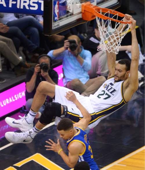 Steve Griffin  |  The Salt Lake Tribune


Utah Jazz center Rudy Gobert (27) hangs on the rim as he throws down a monster dunk as Golden State's Steph Curry gets out of the way during Jazz versus Warriors NBA game at Vivint Smart Home Arena in Salt Lake City, Wednesday, March 30, 2016.