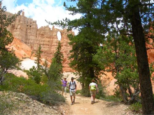 Tribune File Photo

Hikers walk along the Peakaboo Trail in Bryce Canyon National Park. One of The Windows can be seen above.