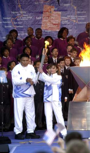 Steve Griffin  |  The Salt Lake Tribune

Muhammad Ali hands off  the Olympic Torch to Peggy Flemming after lighting it from a caldron in Centennial Park in Atlanta Dec. 4, 2001. Ali lit the first torch kicking off the 2002 Olympic Torch Relay that will end up in Salt Lake CIty.