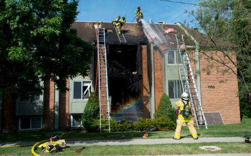 Steve Griffin / The Salt Lake Tribune

Firefighters cut roof vents as they fight an apartment fire on Foothill Dr. near 1100 south Monday in Salt Lake City Monday June 6, 2016.