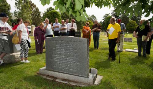 Steve Griffin / The Salt Lake Tribune
Tour leader Darius Gray reads from the graveside memorial for Elder Elijah and Sister Mary Ann Abel at the Salt Lake City Cemetery on Thursday, June 9, 2016. The event was part of a tour in conjunction with the Mormon History Association conference that visited significant sites and stories related to African-Americans in Utah history.
