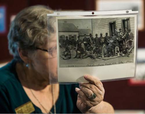 Steve Griffin / The Salt Lake Tribune
Fort Douglas Military Museum's Sue Richards holds a photograph of the Fort Duchesne Band that was racially integrated and made up of the 24th Regiment and the 9th Cavalry as she tells tour members about the 24th  Infantry as they learn about African-Americans in Utah's history during a tour in conjunction with the Mormon History Association conference in Salt Lake City on Thursday, June 9, 2016.
