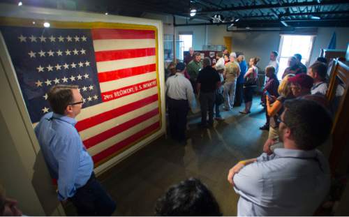 Steve Griffin / The Salt Lake Tribune
Tour members stand next to the battle flag of the 24th Infantry at the Fort Douglas Military Museum as they learn about African-Americans in Utah's history during a tour of in conjunction with the Mormon History Association conference in Salt Lake City on Thursday, June 9, 2016. The 24th Regiment was an entirely African-American regiment and whose members were part of the famed Buffalo Soldiers.