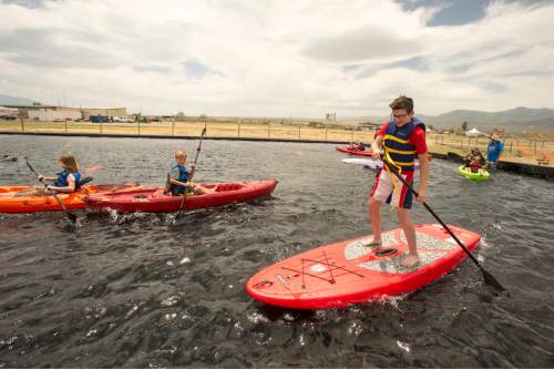 Rick Egan  |  The Salt Lake Tribune

Kids test out kayaks and paddleboards during Outdoor Adventure Days at the Lee Kay Public Shooting Range in Salt Lake City on Friday, June 10, 2016. The free event continues Saturday with fishing, kayaking and paddleboarding, and archery and firearms instruction.