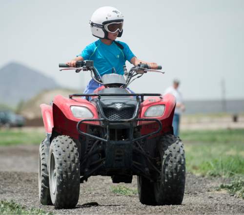 Rick Egan  |  The Salt Lake Tribune

Skyler Salazar takes a ride on an ATV during Outdoor Adventure Days at the Lee Kay Public Shooting Range in Salt Lake City on Friday, June 10, 2016. The free event continues Saturday with fishing, kayaking and paddleboarding, and archery and firearms instruction.