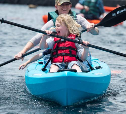 Rick Egan  |  The Salt Lake Tribune

Autumn Davis, 6, paddles a kayak with her mother, Debbie Davis, during Outdoor Adventure Days at the Lee Kay Public Shooting Range in Salt Lake City on Friday, June 10, 2016. The free event continues Saturday with fishing, kayaking and paddleboarding, and archery and firearms instruction.