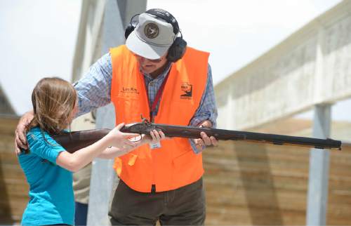 Rick Egan  |  The Salt Lake Tribune

Samantha Allred, 10, shoots a balck powder gun, with the assistance of David George, from Mountain Men of the Wasatch, at the Outdoor Adventure Days, at the Lee Kay Public Shooting Range, 6000 W. 2100 S. in Salt Lake City, Friday, June 10, 2016. The free Adventure Days continues tomorrow from 10 a.m.–7 p.m.  There is fishing, kayaking and paddle boarding on a pond, a variety of firearms, including pistols, rifles, muzzleloaders and shotguns to shoot, or archery.