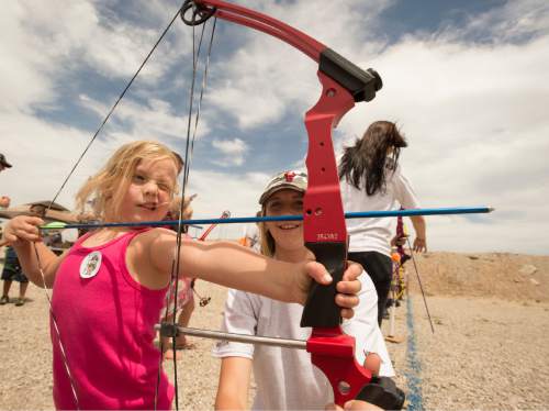 Rick Egan  |  The Salt Lake Tribune

Brystle Jones, 5, shoots an arrow with the assistance of Emma Allred  during Outdoor Adventure Days at the Lee Kay Public Shooting Range in Salt Lake City on Friday, June 10, 2016. The free event continues Saturday with fishing, kayaking and paddleboarding, and archery and firearms instruction.