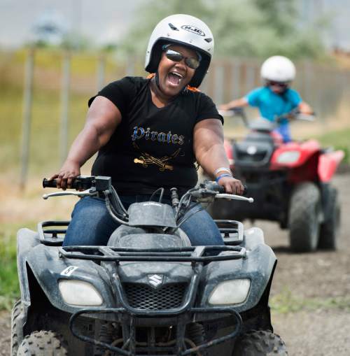 Rick Egan  |  The Salt Lake Tribune

Nakia Armstrong, Salt Lake, smiles as she takes a spin on an ATV for the first time in her life, during Outdoor Adventure Days at the Lee Kay Public Shooting Range in Salt Lake City on Friday, June 10, 2016. The free event continues Saturday with fishing, kayaking and paddleboarding, and archery and firearms instruction.