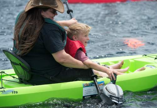 Rick Egan  |  The Salt Lake Tribune

Dolly Case paddles a kayak with her son Lui, 6, during Outdoor Adventure Days at the Lee Kay Public Shooting Range in Salt Lake City on Friday, June 10, 2016. The free event continues Saturday with fishing, kayaking and paddleboarding, and archery and firearms instruction.