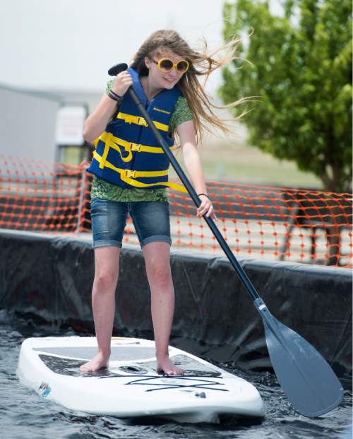 Rick Egan  |  The Salt Lake Tribune

Shaeda Crockett, 14, Layton, tests out a stand-up paddleboard during Outdoor Adventure Days at the Lee Kay Public Shooting Range in Salt Lake City on Friday, June 10, 2016. The free event continues Saturday with fishing, kayaking and paddleboarding, and archery and firearms instruction.
