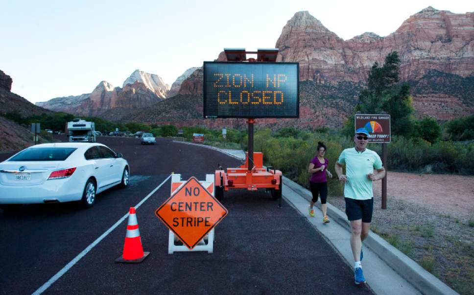 Steve Griffin  |  The Salt Lake Tribune
A sign tells visitors to Zion National Park that the park is closed due to the federal government shutdown Tuesday October 1, 2013.