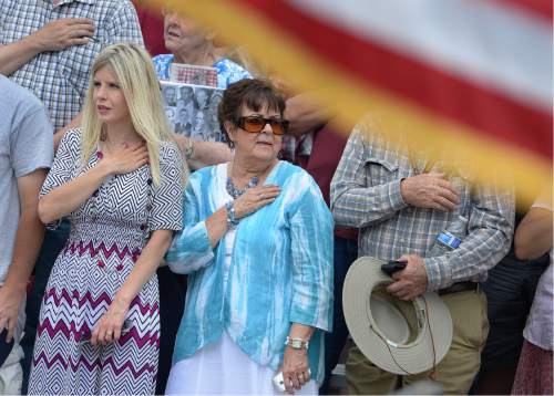 Scott Sommerdorf   |  The Salt Lake Tribune  
Joyce Nelson Stevens, center, whose son Gordon Conover died in the Wilberg fire of 1984, stands during the pledge of allegiance as a pair of statues were unveiled and dedicated to all the miners who have died in Utah mining disasters, Saturday, June 8, 2016.