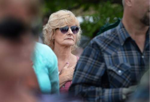 Scott Sommerdorf   |  The Salt Lake Tribune  
Wendy Black, held her hand over her heart during the pledge of allegiance during a ceremony for the new Miners Memorial in Castle Dale, Utah, Saturday, June 8, 2016. Black's husband Dale Black lost his life at Crandall Canyon.