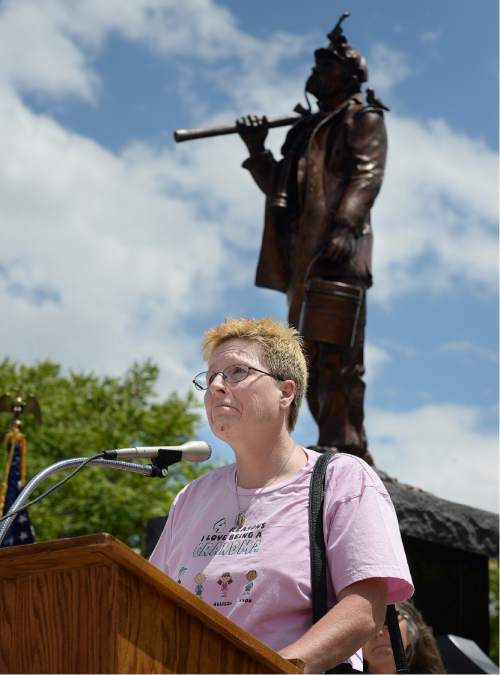 Scott Sommerdorf   |  The Salt Lake Tribune  
Sherry Clement struggles to hold back emotion as she reads the name of her husband Lee Grant Johansson during a ceremony for the new Miners Memorial in Castle Dale, Utah, Saturday, June 8, 2016. Many family members came up one by one to read off the names of those lost in Utah's mining disasters.