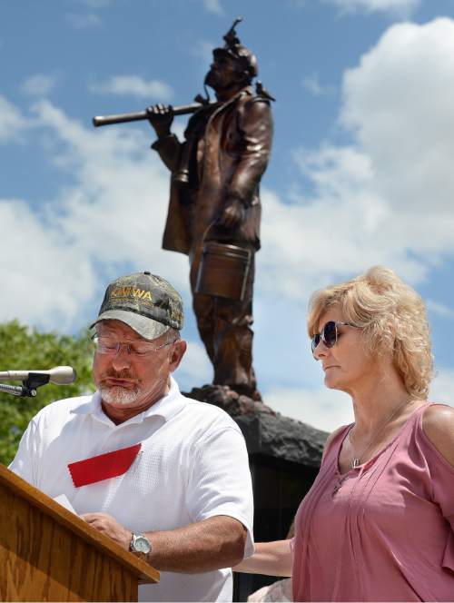 Scott Sommerdorf   |  The Salt Lake Tribune  
Lannie Sitterud, left, is supported by Wendy Black as he reads off the names of miners who have perished in Utah's mining disasters during a ceremony for the new Miners Memorial in Castle Dale, Utah, Saturday, June 8, 2016. Many family members came up one by one to read off the names of those lost in Utah's mining disasters.