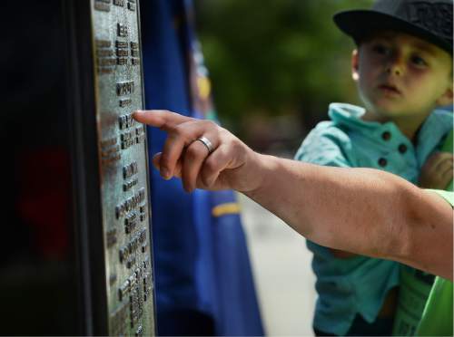 Scott Sommerdorf   |  The Salt Lake Tribune  
Family members waited in line to come up and touch the name of a loved one who was memorialized on the new Miners Memorial in Castle Dale, Utah, Saturday, June 8, 2016.