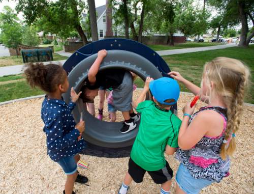 Steve Griffin  |  The Salt Lake Tribune

Children play on the new playground equipment as the Salt Lake City's Public Services Department and the Parks and Public Lands Division open the new Fairmont Park playground Friday, June 10, 2016.