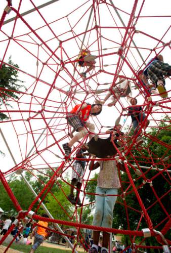 Steve Griffin  |  The Salt Lake Tribune

Children play on the new playground equipment as the Salt Lake Cityís Public Services Department and the Parks and Public Lands Division open the new Fairmont Park playground Friday, June 10, 2016.