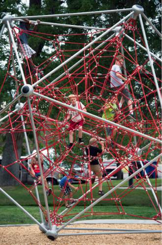 Steve Griffin  |  The Salt Lake Tribune

Children play on the new playground equipment as the Salt Lake City's Public Services Department and the Parks and Public Lands Division open the new Fairmont Park playground Friday, June 10, 2016.