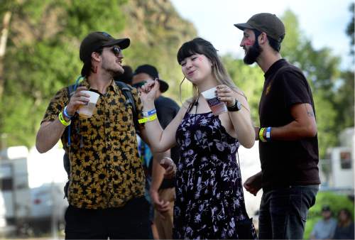 Scott Sommerdorf   |  The Salt Lake Tribune  
Baker Weiler, left, Alicia Malloy and Levi Weiler dance as they listen to "Young Empires" on the Shade Stage at Bonanza Campout at Rivers Edge Resort in Heber on Friday, June 8.