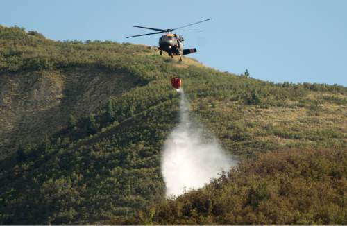 Rick Egan  |  The Salt Lake Tribune

Helicopters drop water on a wildfire near Mountain Dell, in Parley's Canyon, Saturday, August 15, 2015.