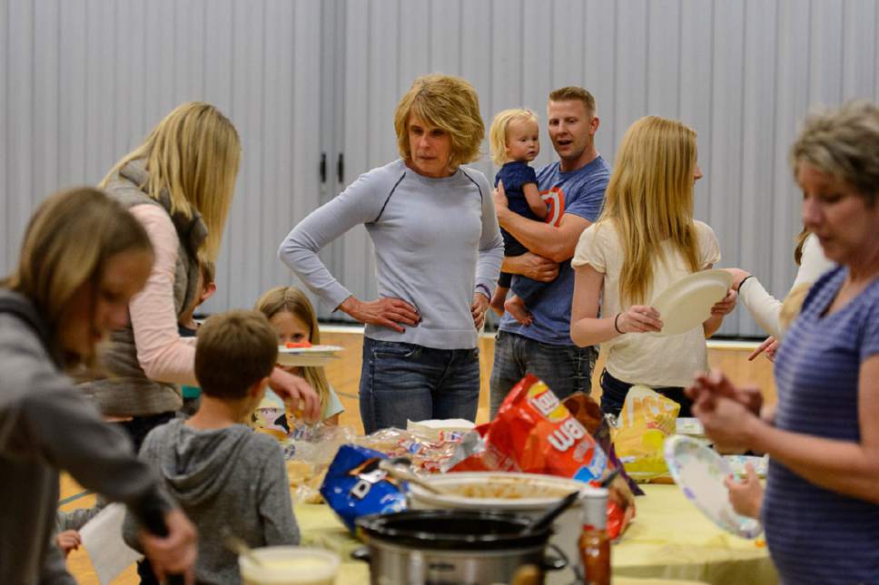 Trent Nelson  |  The Salt Lake Tribune
Bonnie De Jong and family fill plates with food, Saturday May 7, 2016. Mother's Day for Stan and Bonnie De Jong of Sandy, includes a picnic on Saturday when their five children and 11 grandchildren can visit with mom on her special day. Bonnie was diagnosed with Alzheimer's disease 3 years ago after recovering from a hematoma surgery and began have trouble with her memory.