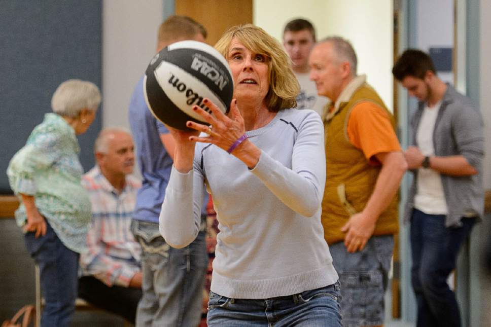 Trent Nelson  |  The Salt Lake Tribune
Bonnie De Jong shoots a basketball while surrounded by extended family, Saturday May 7, 2016. Mother's Day for Stan and Bonnie De Jong of Sandy, includes a picnic on Saturday when their five children and 11 grandchildren can visit with mom on her special day. Bonnie was diagnosed with Alzheimer's disease 3 years ago after recovering from a hematoma surgery and began have trouble with her memory.