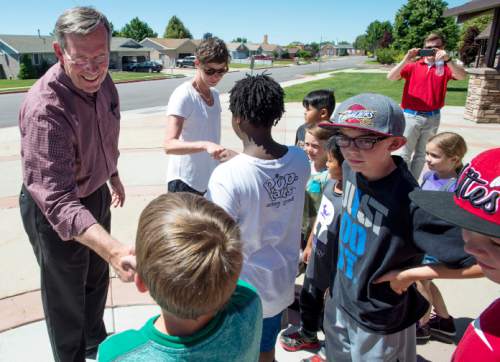 Steve Griffin / The Salt Lake Tribune

Former Gov. Mike Leavitt and Weber County Commission candidate Caitlin Gochnour stop to chat with children from the Boys and Girls Clubs of Weber-Davis the as they walk a Roy, Utah neighborhood with local candidates who support Count My Vote election reforms. The group met at the Roy Hillside Senior Citizen Center in Roy, Utah Friday June 17, 2016.