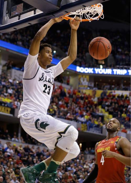 FILE - In this March 12, 2016, file photo, Michigan State's Deyonta Davis (23) dunks as Maryland's Robert Carter (4) watches in the second half of an NCAA college basketball game during the semifinals of the Big Ten Conference tournament in Indianapolis. Deyonta Davis is entering NBA draft after one season at Michigan State. The school announced his decision Tuesday, April 12, 2016. (AP Photo/Michael Conroy, File)