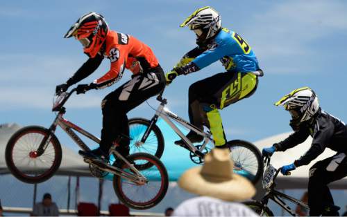 Leah Hogsten  |  The Salt Lake Tribune
l-r Kenneth Gustafson, Jacob Pebbles and Thomas Zula fight to qualify in the men's elite class. USA BMX's Great Salt Lake National meet featured riders under 5 to 75-years-old and even a couple Rio-bound Olympic athletes, Saturday, June 18, 2016 at the Rad Canyon BMX track in South Jordan.