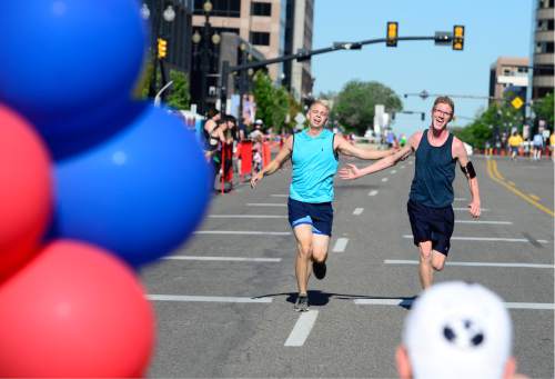 Scott Sommerdorf   |  The Salt Lake Tribune  
Two men finish the 5K race prior to the 2016 Pride Parade, Sunday, June 5, 2016.