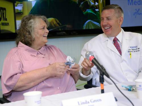 Al Hartmann  |  The Salt Lake Tribune
Kidney surgery patient Linda Green, laughs as she recieives a 3D model of her kidney tumor as a gift from Jay Bishhoff, MD, director of  Intermountain Urological Institute at a news conference at Intermountain Medical Center in Murray on Monday June 20. Staff at Intermountain Medical Center printed and used a 3D model of a Linda Green's kidney to help them preserve the organ during a complicated tumor-removal procedural.