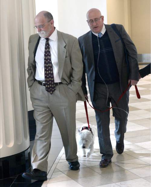 Al Hartmann  |  The Salt Lake Tribune
Timothy Lawson, right, dubbed a "fixer" for former Utah Attorney General Mark Shurtleff leaves Judge Katie Bernards-Goodman's courtroom in Salt Lake City Monday April 25 with his defense lawyer Ron Yengich and his service dog Prince at his side. 
Lawson is charged with six felonies -- including counts of tax evasion, witness tampering, obstruction of justice and a pattern of unlawful conduct -- stemming from allegations that he attempted to intimidate or threaten individuals with ties to Shurtleff and his successor, John Swallow.