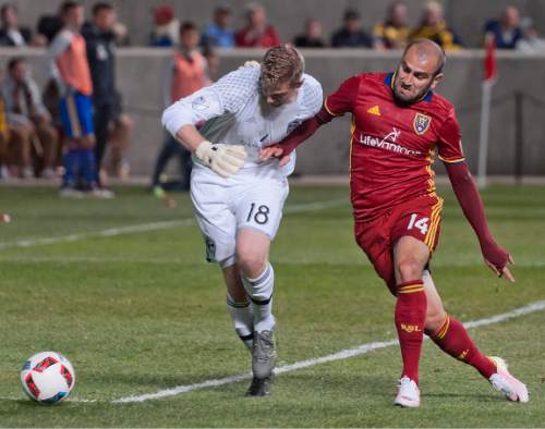 Michael Mangum  |  Special to the Tribune

Real Salt Lake forward Yura Movsisyan (14) pressures Colorado Rapids goalkeeper Zac MacMath (18) at the 6-yard box line during the second half their match at Rio Tinto Stadium in Sandy, UT on Saturday, April 9, 2016. RSL won 1-0.