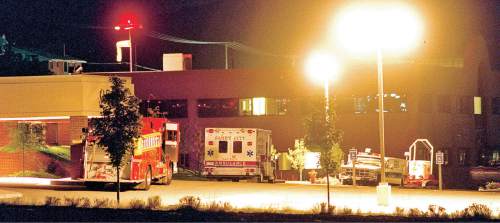 Tribune file photo
While Richard Worthington held hospital staff hostage inside, emergency vehicles, including a bomb disposal truck, far right, wait outside the Alta View Hospital.