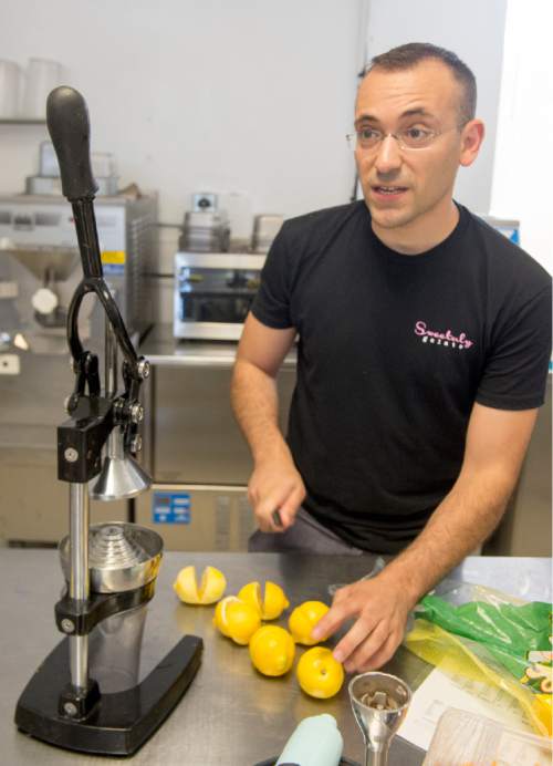 Rick Egan  |  The Salt Lake Tribune

Francesco Amendola pours squeezes fresh lemon juice, as he makes lemon sorbet at his Sweetaly gelato shop on 3300 South, Friday, June 3, 2016.