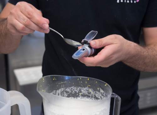 Rick Egan  |  The Salt Lake Tribune

Francesco Amendola uses a refractometer to check the solid's in the mixture, as he makes lemon sorbet at his Sweetaly gelato shop on 3300 South, Friday, June 3, 2016.
