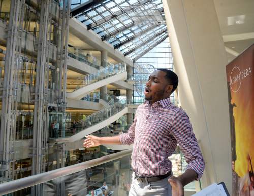 Al Hartmann  |  The Salt Lake Tribune 
Markel Reed, a baritone with Utah Opera, sings from a high balcony in a "pop-up" performance in the atrium of City Library on Thursday, June 23, the first afternoon of the Utah Arts Festival.  
"Random acts" of art, like this performance happen away from the traditional stages at the Utah Arts Festival.