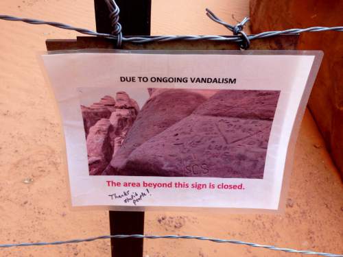 Erin Alberty  |  The Salt Lake Tribune

A sign displays the consequence of vandalism on ancient rock formations near Sand Dune Arch in Arches National Park.