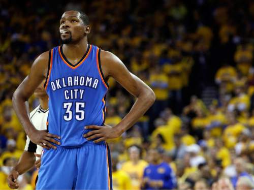 FILE - In this May 26, 2016, file photo, Oklahoma City Thunder's Kevin Durant watches during the closing minutes of the second half in Game 5 of the NBA basketball Western Conference finals against the Golden State Warriors in Oakland, Calif. Durant may not be ready to talk about his free agency yet, but it's one of the biggest issues facing the Oklahoma City Thunder after losing in seven games of the Western Conference finals to Golden State. (AP Photo/Marcio Jose Sanchez, File)